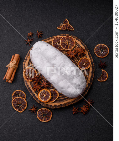 Stollen, a German Christmas pastry for the winter holidays. Stollen as a food background Stollen, a German Christmas pastry for the winter holidays. Stollen as a food background 134680027