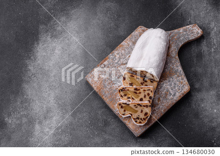 Stollen, a German Christmas pastry for the winter holidays. Stollen as a food background 134680030