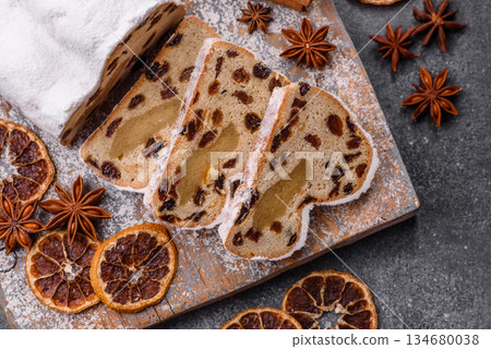 Stollen, a German Christmas pastry for the winter holidays. Stollen as a food background Stollen, a German Christmas pastry for the winter holidays. Stollen as a food background 134680038