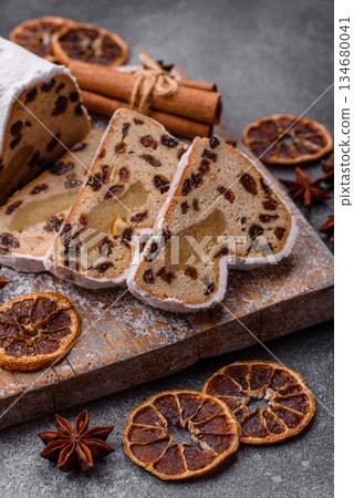 Stollen, a German Christmas pastry for the winter holidays. Stollen as a food background Stollen, a German Christmas pastry for the winter holidays. Stollen as a food background 134680041