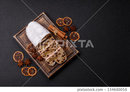 Stollen, a German Christmas pastry for the winter holidays. Stollen as a food background Stollen, a German Christmas pastry for the winter holidays. Stollen as a food background 134680058