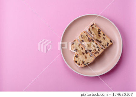 Stollen, a German Christmas pastry for the winter holidays. Stollen as a food background Stollen, a German Christmas pastry for the winter holidays. Stollen as a food background 134680107