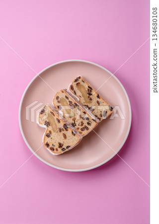 Stollen, a German Christmas pastry for the winter holidays. Stollen as a food background Stollen, a German Christmas pastry for the winter holidays. Stollen as a food background 134680108