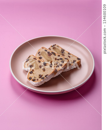 Stollen, a German Christmas pastry for the winter holidays. Stollen as a food background Stollen, a German Christmas pastry for the winter holidays. Stollen as a food background 134680109