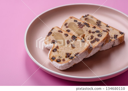 Stollen, a German Christmas pastry for the winter holidays. Stollen as a food background Stollen, a German Christmas pastry for the winter holidays. Stollen as a food background 134680110