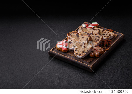 Stollen, a German Christmas pastry for the winter holidays. Stollen as a food background Stollen, a German Christmas pastry for the winter holidays. Stollen as a food background 134680202