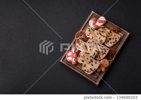 Stollen, a German Christmas pastry for the winter holidays. Stollen as a food background Stollen, a German Christmas pastry for the winter holidays. Stollen as a food background 134680203