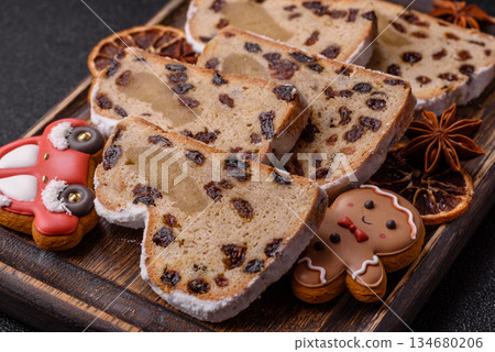 Stollen, a German Christmas pastry for the winter holidays. Stollen as a food background Stollen, a German Christmas pastry for the winter holidays. Stollen as a food background 134680206