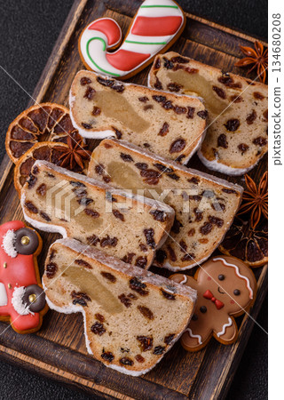 Stollen, a German Christmas pastry for the winter holidays. Stollen as a food background Stollen, a German Christmas pastry for the winter holidays. Stollen as a food background 134680208