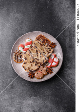 Stollen, a German Christmas pastry for the winter holidays. Stollen as a food background Stollen, a German Christmas pastry for the winter holidays. Stollen as a food background 134680223