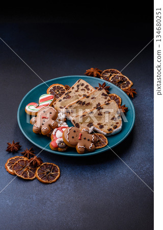 Stollen, a German Christmas pastry for the winter holidays. Stollen as a food background Stollen, a German Christmas pastry for the winter holidays. Stollen as a food background 134680251