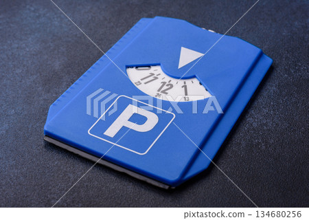 A parking disc, permit, or ticket for measuring time and paying municipal services. A parking disc A parking disc, permit, or ticket for measuring time and paying municipal services. A parking disc 134680256