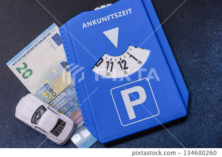 A parking disc, permit, or ticket for measuring time and paying municipal services. A parking disc A parking disc, permit, or ticket for measuring time and paying municipal services. A parking disc 134680260