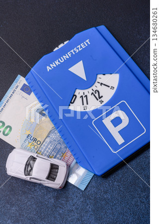 A parking disc, permit, or ticket for measuring time and paying municipal services. A parking disc A parking disc, permit, or ticket for measuring time and paying municipal services. A parking disc 134680261