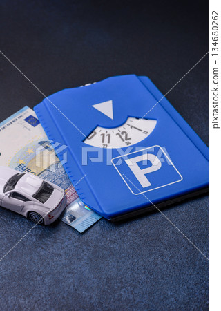 A parking disc, permit, or ticket for measuring time and paying municipal services. A parking disc A parking disc, permit, or ticket for measuring time and paying municipal services. A parking disc 134680262
