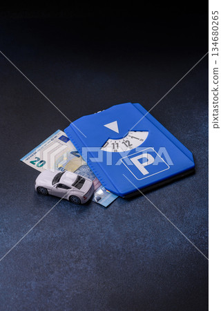 A parking disc, permit, or ticket for measuring time and paying municipal services. A parking disc 134680265