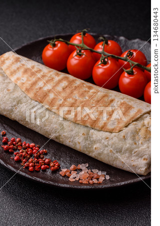 Shawarma with chicken or beef, tortilla roll, and vegetables. Shawarma with meat Shawarma with chicken or beef, tortilla roll, and vegetables. Shawarma with meat 134680443