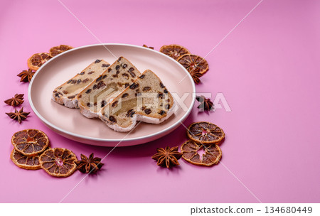 Stollen, a German Christmas pastry for the winter holidays. Stollen as a food background Stollen, a German Christmas pastry for the winter holidays. Stollen as a food background 134680449