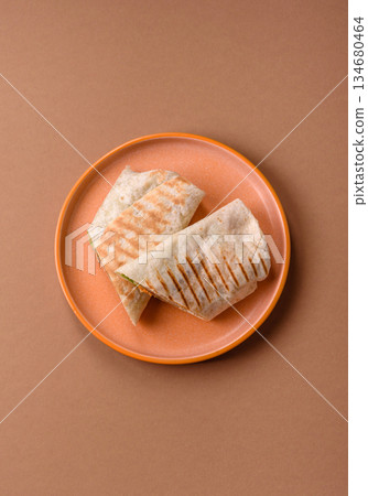 Shawarma with chicken or beef, tortilla roll, and vegetables. Shawarma with meat 134680464