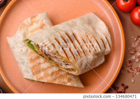 Shawarma with chicken or beef, tortilla roll, and vegetables. Shawarma with meat 134680471
