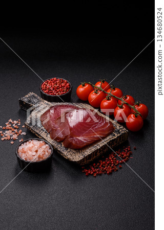 Tuna steak for sashimi or sushi, smoked fish. Tuna steak as a food background 134680524
