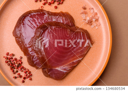 Tuna steak for sashimi or sushi, smoked fish. Tuna steak as a food background Tuna steak for sashimi or sushi, smoked fish. Tuna steak as a food background 134680534