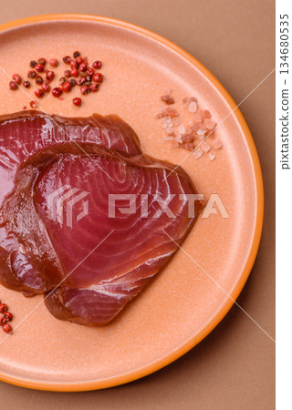 Tuna steak for sashimi or sushi, smoked fish. Tuna steak as a food background Tuna steak for sashimi or sushi, smoked fish. Tuna steak as a food background 134680535