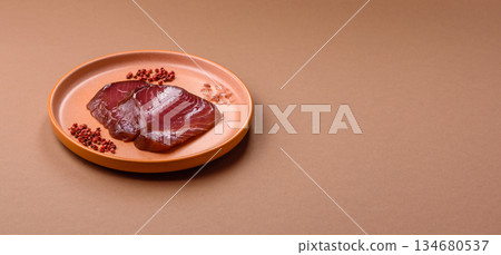 Tuna steak for sashimi or sushi, smoked fish. Tuna steak as a food background Tuna steak for sashimi or sushi, smoked fish. Tuna steak as a food background 134680537