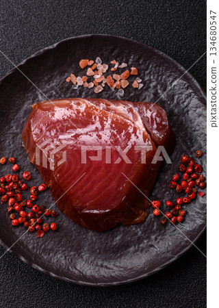 Tuna steak for sashimi or sushi, smoked fish. Tuna steak as a food background Tuna steak for sashimi or sushi, smoked fish. Tuna steak as a food background 134680547