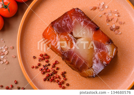 Tuna and salmon roll, smoked fish. Tuna and salmon roll as a food background Tuna and salmon roll, smoked fish. Tuna and salmon roll as a food background 134680576