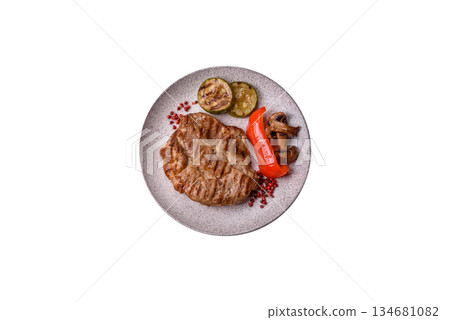 Grilled beef or pork steak, healthy restaurant food for lunch. Barbecue steak as a background Grilled beef or pork steak, healthy restaurant food for lunch. Barbecue steak as a background 134681082