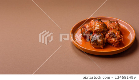 Hake fish cooked in pieces in tomato sauce, stew with peppers and carrots. Hake fish in tomato 134681499