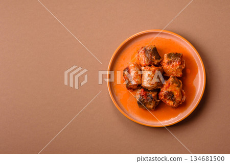 Hake fish cooked in pieces in tomato sauce, stew with peppers and carrots. Hake fish in tomato Hake fish cooked in pieces in tomato sauce, stew with peppers and carrots. Hake fish in tomato 134681500