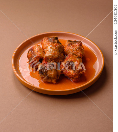 Hake fish cooked in pieces in tomato sauce, stew with peppers and carrots. Hake fish in tomato Hake fish cooked in pieces in tomato sauce, stew with peppers and carrots. Hake fish in tomato 134681502