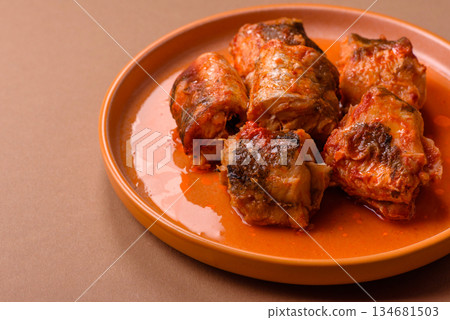 Hake fish cooked in pieces in tomato sauce, stew with peppers and carrots. Hake fish in tomato 134681503