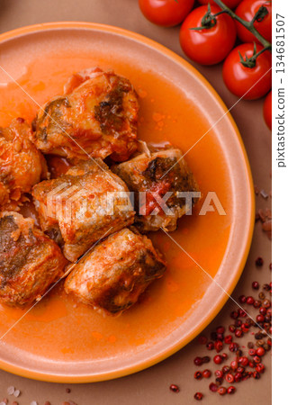 Hake fish cooked in pieces in tomato sauce, stew with peppers and carrots. Hake fish in tomato Hake fish cooked in pieces in tomato sauce, stew with peppers and carrots. Hake fish in tomato 134681507