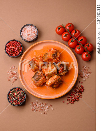 Hake fish cooked in pieces in tomato sauce, stew with peppers and carrots. Hake fish in tomato Hake fish cooked in pieces in tomato sauce, stew with peppers and carrots. Hake fish in tomato 134681511