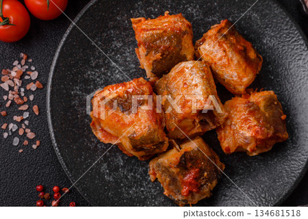 Hake fish cooked in pieces in tomato sauce, stew with peppers and carrots. Hake fish in tomato 134681518