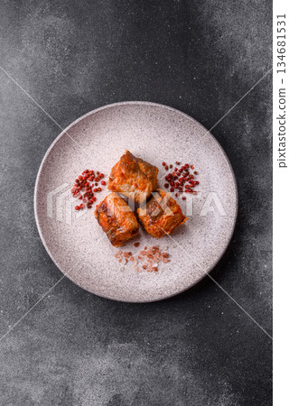 Hake fish cooked in pieces in tomato sauce, stew with peppers and carrots. Hake fish in tomato Hake fish cooked in pieces in tomato sauce, stew with peppers and carrots. Hake fish in tomato 134681531