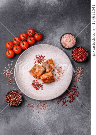 Hake fish cooked in pieces in tomato sauce, stew with peppers and carrots. Hake fish in tomato 134681541