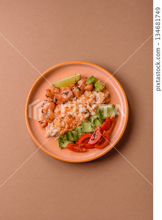 A food bowl with salmon, rice, avocado, tomatoes, and cucumbers. A salmon bowl A food bowl with salmon, rice, avocado, tomatoes, and cucumbers. A salmon bowl 134681749