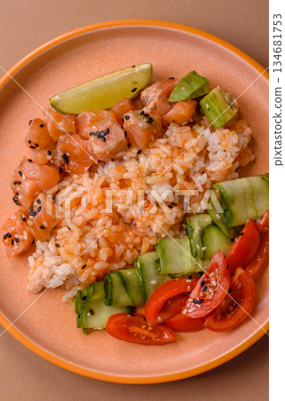 A food bowl with salmon, rice, avocado, tomatoes, and cucumbers. A salmon bowl A food bowl with salmon, rice, avocado, tomatoes, and cucumbers. A salmon bowl 134681753