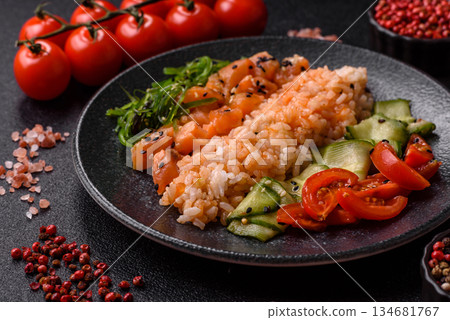 A food bowl with salmon, rice, avocado, tomatoes, and cucumbers. A salmon bowl 134681767
