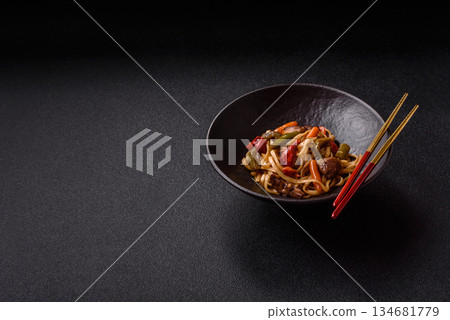 Asian food, noodles with vegetables, vegetarian dish with spicy sauce. Noodles with vegetables Asian food, noodles with vegetables, vegetarian dish with spicy sauce. Noodles with vegetables 134681779