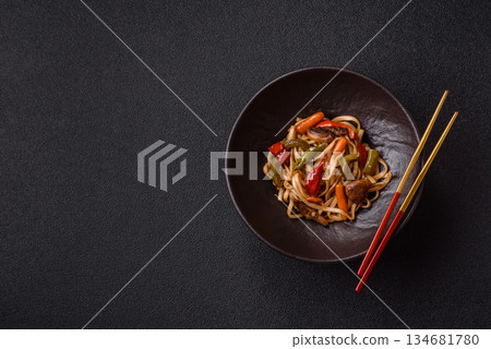 Asian food, noodles with vegetables, vegetarian dish with spicy sauce. Noodles with vegetables Asian food, noodles with vegetables, vegetarian dish with spicy sauce. Noodles with vegetables 134681780