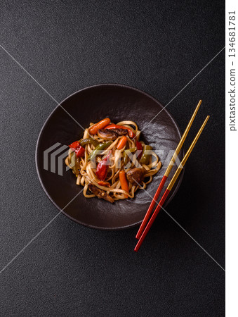 Asian food, noodles with vegetables, vegetarian dish with spicy sauce. Noodles with vegetables Asian food, noodles with vegetables, vegetarian dish with spicy sauce. Noodles with vegetables 134681781
