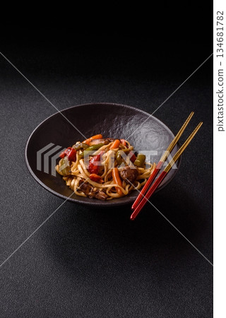 Asian food, noodles with vegetables, vegetarian dish with spicy sauce. Noodles with vegetables Asian food, noodles with vegetables, vegetarian dish with spicy sauce. Noodles with vegetables 134681782
