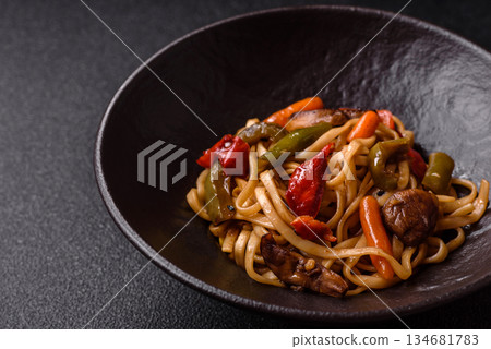 Asian food, noodles with vegetables, vegetarian dish with spicy sauce. Noodles with vegetables Asian food, noodles with vegetables, vegetarian dish with spicy sauce. Noodles with vegetables 134681783