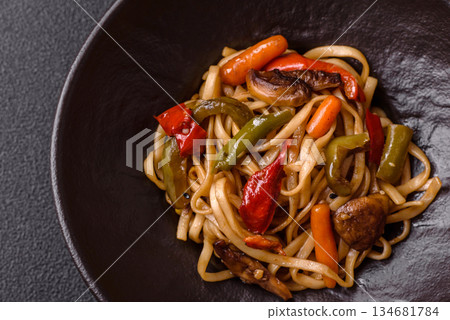 Asian food, noodles with vegetables, vegetarian dish with spicy sauce. Noodles with vegetables Asian food, noodles with vegetables, vegetarian dish with spicy sauce. Noodles with vegetables 134681784