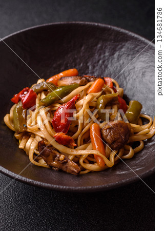 Asian food, noodles with vegetables, vegetarian dish with spicy sauce. Noodles with vegetables Asian food, noodles with vegetables, vegetarian dish with spicy sauce. Noodles with vegetables 134681786